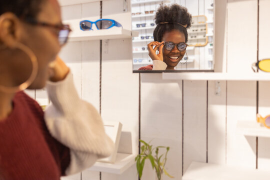Woman trying on sunglasses in a stylish boutique