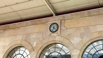 Antique railway clock echoes time's whispers, stone arches hold secrets of bygone journeys,...