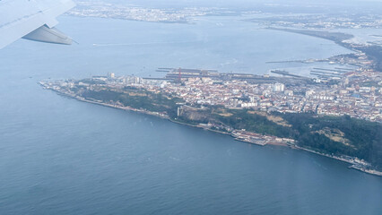 Serene aerial view over Lisbon  coastal tapestry drama, merging industrial whispers and verdant...