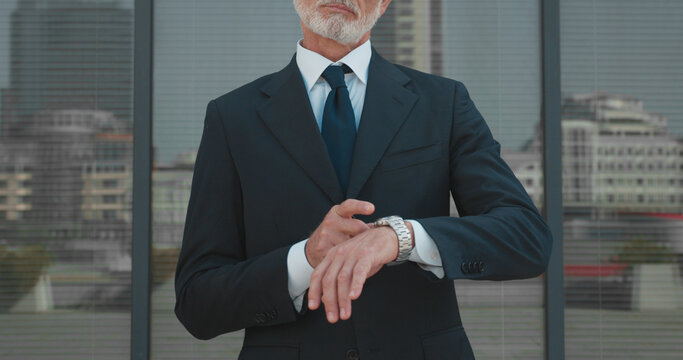 Busy male boss pointing at watch, time management, work pressure, business deadline