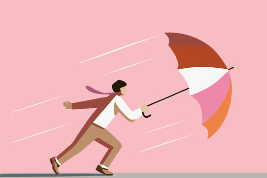 Businessman struggling against strong wind with umbrella. Adversity concept.