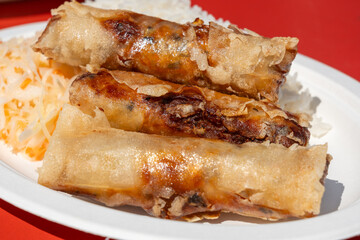 Fried spring rolls. Crispy springrolls, roasted egg rolls with boiled rice and cabbage salad