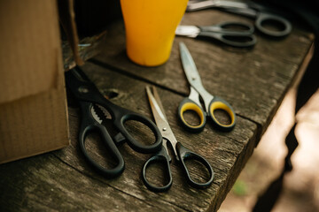 Various scissors lie on a wooden table