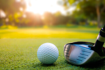 Close-Up of Golf Ball and Driver Club on Sunlit Green Landscape