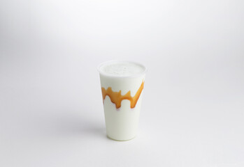 Milkshake with syrup in a glass. on a white background.