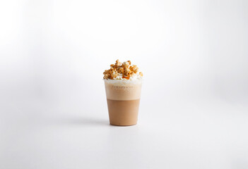 Cappuccino coffee with nuts in a glass. on a white background.