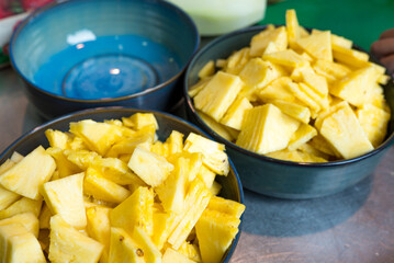 fresh pineapple chunks, healthy sweet fruit snack in ceramic bowls