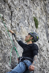 Adventurous rock climber scaling a challenging cliff in the great outdoors