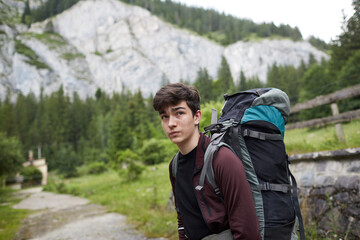 Young hiker pauses to take in the breathtaking mountain view during an outdoor adventure