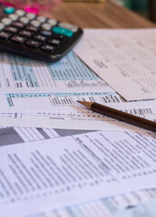 Planning, Budget, and Tax Concept. Individual Income 1040 Tax Form For Have Income According to United States Law. Tax form, calculator, and pen on desk. Season to pay, and deadline for tax payment.