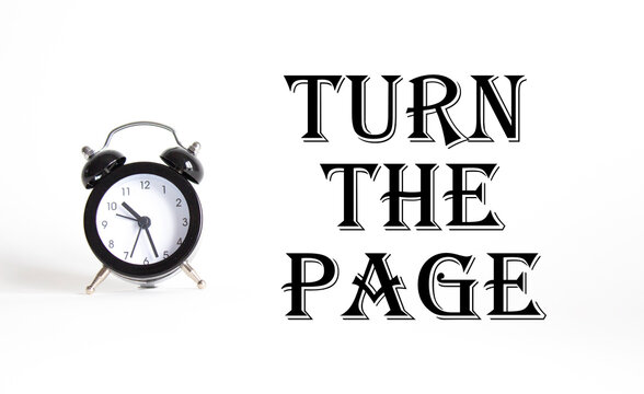 Turn the Page symbol. Concept words Turn the Page on Beautiful white background with alarm clock. Business and Turn the Page concept. Copy space.