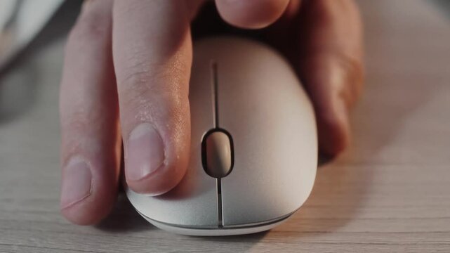 mans hand on a computer mouse is spinning a wheel