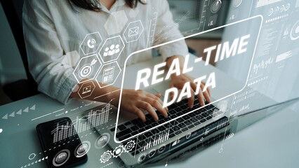 Modern Businesswoman Analyzing Real-Time Data on Laptop with Graphical Interface Elements....