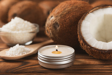 Natural coconut wax candles on a wooden table. Homemade eco-friendly coconut wax candles with aromatic oil. Candles for massage. Spa. Relax. Aromatherapy. Copy space. Vegan product.