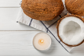 Natural coconut wax candles on a wooden table. Homemade eco-friendly coconut wax candles with...