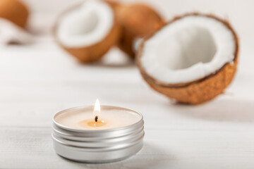 Natural coconut wax candles on a wooden table. Homemade eco-friendly coconut wax candles with aromatic oil. Candles for massage. Spa. Relax. Aromatherapy. Copy space. Vegan product.