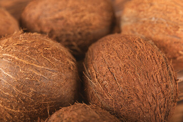 Set of fresh whole and half coconuts and slices on wooden background. Coconut flakes. Vegan....