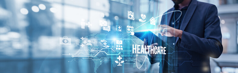 Plakat Businessman using tablet analyzing healthcare and technology-driven growth trends reveals the transformative impact of AI-powered diagnostics, telehealth expansion, digital innovation accelerating.