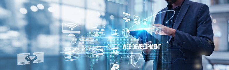 Businessman using tablet analyzing web development and digital marketing growth trends, user engagement, SEO optimization, mobile responsiveness, cybersecurity measures, and scalability strategies.