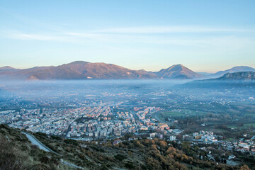 Panoramic view of a mountain valley in an Italian town at dawn.