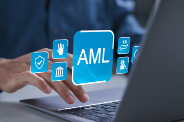 AML, Anti money laundering financial bank concept. Businessman using laptop with AML icons on virtual screen for anti money laundering regulations.