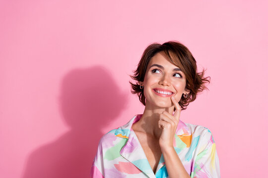 Portrait of pretty young girl look empty space wear shirt isolated on pink color background