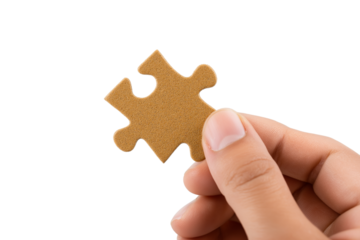 person's hand holding single puzzle piece isolated on white background
