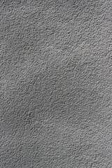    Vertical photo of a gray concrete wall.