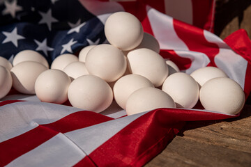 Chicken eggs with the US flag in the background. Countryside outdoor setting