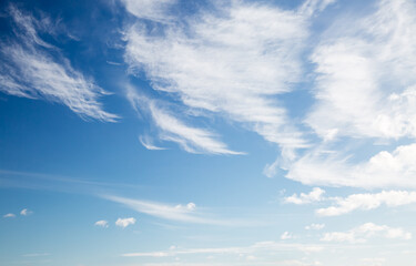 A serene view of the sky filled with white cirrus clouds against a vivid blue backdrop.