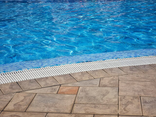Clear Water at the Bottom of the Swimming Pool Empty Space Blue Tiles Background