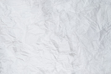Crumpled white paper background.