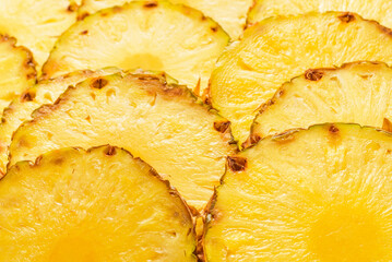 Pineapple juicy yellow slices background. Top view.