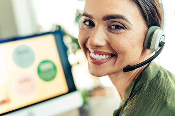 Friendly businesswoman wearing a headset providing excellent customer support services in a...