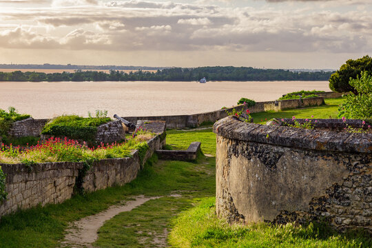 Blaye, Bordeaux region, France, sunset over the Gironde estuary with citadel fortress in the foreground, peaceful and colorful summer evening