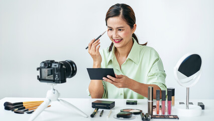 Woman blogger is showing present make up tutorial beauty cosmetic review product and broadcast live...
