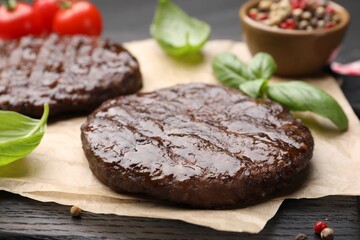 Delicious hamburger patties and spices on table, closeup