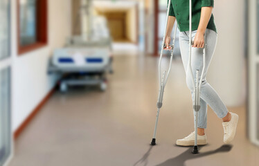 Woman with axillary crutches in hospital, closeup. Banner design