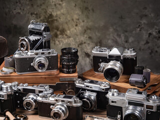 Collection of old cameras, on wooden background.