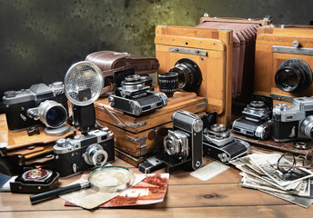 Collection of old cameras, on wooden background.