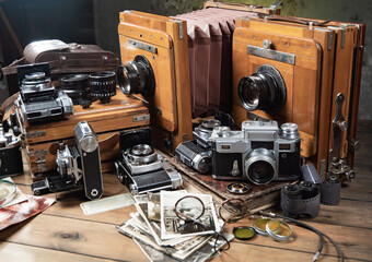 Collection of old cameras, on wooden background.