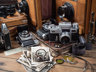 Collection of old cameras, on wooden background.