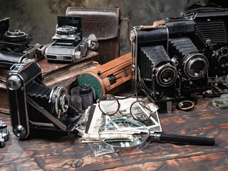 Collection of old cameras, on wooden background.