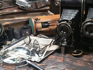 Collection of old cameras, on wooden background.