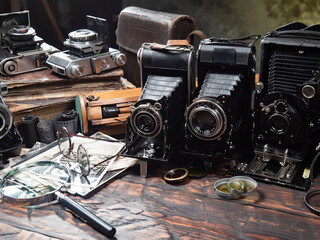 Collection of old cameras, on wooden background.