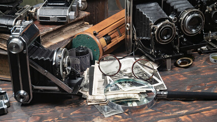 Collection of old cameras, on wooden background.