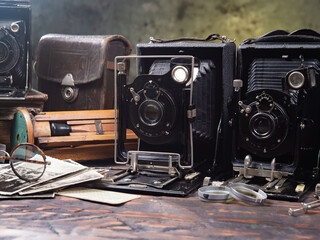 Collection of old cameras, on wooden background.