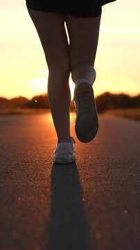 silhouette sports girl running legs along road sunset, sports morning dawn, runner fitness training, healthy running concept, triathlete running, athlete runner training stadium, fit athletic girl