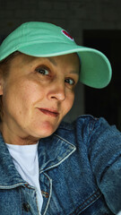 woman middle 40 years old portrait close-up in jacket and cap