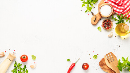 Spices, herbs and vegetables with olive oil on white kitchen table.